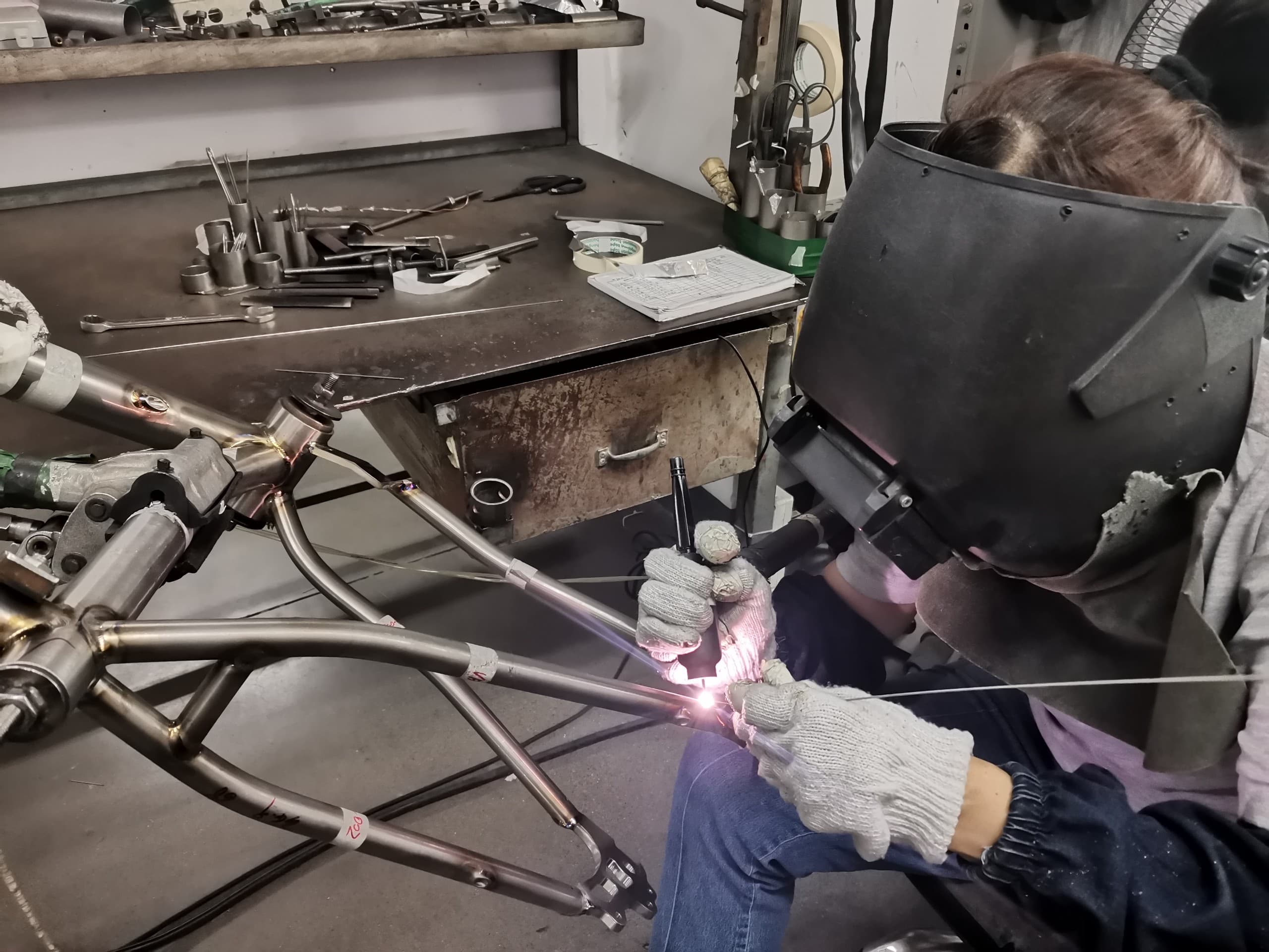 Hand-welded titanium frame on workshop stand